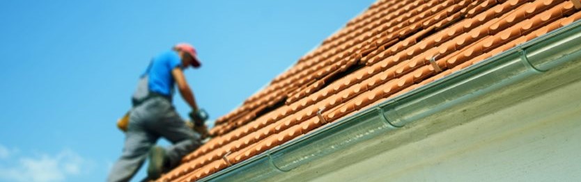 Roofing contractor working during a sunny day